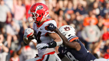 Auburn footballOct 9, 2021; Auburn, Alabama, USA; Georgia Bulldogs wide receiver Ladd McConkey (84) drags Auburn Tigers cornerback Nehemiah Pritchett (18) into the end zone during the third quarter at Jordan-Hare Stadium. Mandatory Credit: John Reed-USA TODAY Sports