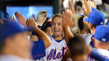 Jul 1, 2016; New York City, NY, USA; New York Mets right fielder Brandon Nimmo (9) is congratulated in the dugout after hitting a three run home run against the Chicago Cubs during the fourth inning at Citi Field. Mandatory Credit: Brad Penner-USA TODAY Sports