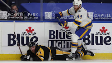 Mar 11, 2021; Buffalo, New York, USA; Buffalo Sabres defenseman Matthew Irwin (44) checks Pittsburgh Penguins center Evgeni Malkin (71) and takes a penalty during the first period at KeyBank Center. Mandatory Credit: Timothy T. Ludwig-USA TODAY Sports