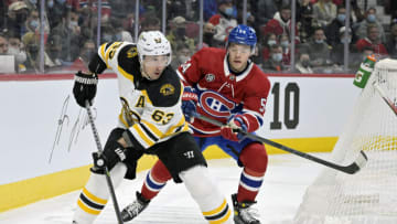 Apr 24, 2022; Montreal, Quebec, CAN; Boston Bruins forward Brad Marchand (63) plays the puck and Montreal Canadiens defenseman Jordan Harris (54) defends during the first period at the Bell Centre. Mandatory Credit: Eric Bolte-USA TODAY Sports