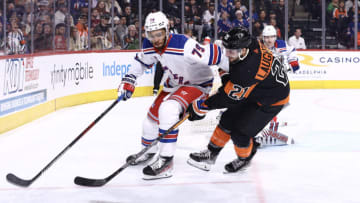 PHILADELPHIA, PENNSYLVANIA - DECEMBER 17: K'Andre Miller #79 of the New York Rangers and Scott Laughton #21 of the Philadelphia Flyers challenge for the puck during the second period at Wells Fargo Center on December 17, 2022 in Philadelphia, Pennsylvania. (Photo by Tim Nwachukwu/Getty Images)