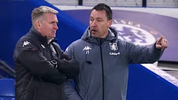 Aston Villa's English head coach Dean Smith (L) and Aston Villa's English assistant coach John Terry (R) talk on the touchline during the English Premier League football match between Chelsea and Aston Villa at Stamford Bridge in London on December 28, 2020. (Photo by John Walton / POOL / AFP) / RESTRICTED TO EDITORIAL USE. No use with unauthorized audio, video, data, fixture lists, club/league logos or 'live' services. Online in-match use limited to 120 images. An additional 40 images may be used in extra time. No video emulation. Social media in-match use limited to 120 images. An additional 40 images may be used in extra time. No use in betting publications, games or single club/league/player publications. / (Photo by JOHN WALTON/POOL/AFP via Getty Images)