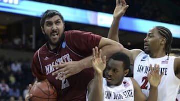 Mar 20, 2014; Spokane, WA, USA; New Mexico State Aggies center Sim Bhullar (2) drives to the basket against San Diego State Aztecs guard Xavier Thames (2) and forward Josh Davis (22) in the second half of a men