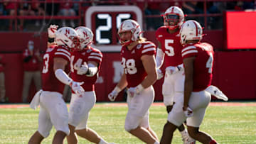 Oct 30, 2021; Lincoln, Nebraska, USA; Nebraska Cornhuskers defenders celebrate as they walk off the field after getting a stop against the Purdue Boilermakers in the second quarter at Memorial Stadium. Mandatory Credit: Dylan Widger-USA TODAY Sports