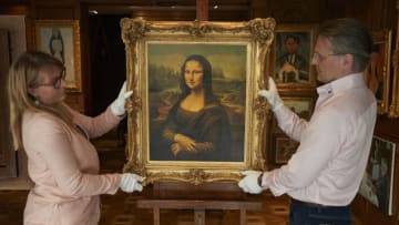 PARIS, FRANCE - MAY 22: Christophe Petyt and Pauline Lepreux hang a copy of Leonardo Da Vinci’s Mona Lisa, the centre piece in an exhibition of fake masterpieces at the Marc-Arthur Kohn Gallery in Paris, ahead of their sale by auction next month on May 22, 2019 in Paris, France. The collection of 120 pieces of perfect copies of famous artists, ranging from Van Gogh, Monet, Renoir, Degas and Leonardo da Vinci, belonging to collector Christophe Petyt, will be a first for the Parisian auction house Drouot when they go under ther hammer on June 4th. (Photo by Kiran Ridley/Getty Images)