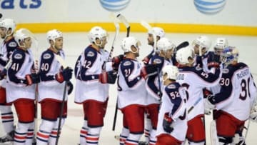 Sep 29, 2014; Nashville, TN, USA; Columbus Blue Jackets goalie Curtis McElhinney (30) is congratulated by teammates after a win against the Nashville Predators at Bridgestone Arena. The Blue Jackets won 3-0. Mandatory Credit: Christopher Hanewinckel-USA TODAY Sports