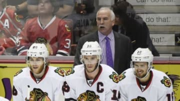 May 30, 2015; Anaheim, CA, USA; Chicago Blackhawks head coach Joel Quenneville stands behind players Patrick Kane (88) , Jonathan Toews (19) and Marcus Kruger (16) in the third period of game seven of the Western Conference Final of the 2015 Stanley Cup Playoffs against the Anaheim Ducks at Honda Center. Mandatory Credit: Richard Mackson-USA TODAY Sports