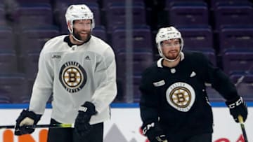 ST. LOUIS, MO - JUNE 2: Boston Bruins teammates David Backes, left, and Connor Clifton, right, smile on the ice during a practice in preparation for Game 4 of the 2019 Stanley Cup Finals against the St. Louis Blues at the Enterprise Center in St. Louis on June 2, 2019. (Photo by Jim Davis/The Boston Globe via Getty Images)
