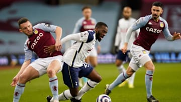 Aston Villa's Scottish midfielder John McGinn (L) tackles Tottenham Hotspur's French midfielder Tanguy Ndombele (C) during the English Premier League football match between Aston Villa and Tottenham Hotspur at Villa Park in Birmingham, central England on March 21, 2021. Photo by TIM KEETON/POOL/AFP via Getty Images)