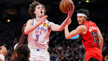 Josh Giddey #3 of the Oklahoma City Thunder goes to the basket against Yuta Watanabe #18 of the Toronto Raptors during the first half of their basketball game at the Scotiabank Arena on December 8, 2021 in Toronto, Ontario, Canada. NOTE TO USER: User expressly acknowledges and agrees that, by downloading and/or using this Photograph, user is consenting to the terms and conditions of the Getty Images License Agreement. (Photo by Mark Blinch/Getty Images)