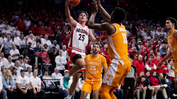 Dec 17, 2022; Tucson, Arizona, USA; Arizona Wildcats guard Kerr Kriisa (25) drives to the the basket against Tennessee Volunteers forward Tobe Awaka (11) and guard Santiago Vescovi (25) during the second half at McKale Center. Mandatory Credit: Zachary BonDurant-USA TODAY Sports