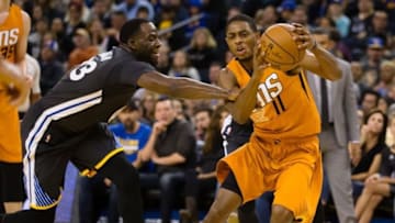 Dec 3, 2016; Oakland, CA, USA; Phoenix Suns guard Brandon Knight (11) is fouled by Golden State Warriors forward Draymond Green (23) on a drive during the third quarter at Oracle Arena. The Golden State Warriors defeated the Phoenix Suns 138-109. Mandatory Credit: Kelley L Cox-USA TODAY Sports