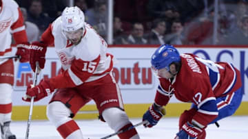 Mar 29, 2016; Montreal, Quebec, CAN; Detroit Red Wings forward Riley Sheahan (15) plays the puck and Montreal Canadiens forward Sven Andrighetto (42) defends during the first period at the Bell Centre. Mandatory Credit: Eric Bolte-USA TODAY Sports