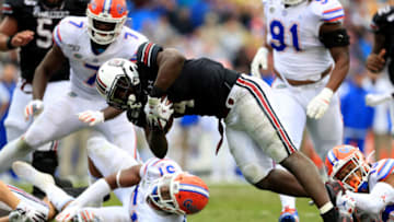 COLUMBIA, SOUTH CAROLINA - OCTOBER 19: Tavien Feaster #4 of the South Carolina Gamecocks is tackled by Donovan Stiner #13 of the Florida Gators during their game at Williams-Brice Stadium on October 19, 2019 in Columbia, South Carolina. (Photo by Streeter Lecka/Getty Images)