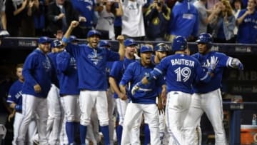 Oct 14, 2015; Toronto, Ontario, CAN; Toronto Blue Jays right fielder Jose Bautista (19) reacts with teammates after hitting a three-run home run against the Texas Rangers in the 7th inning in game five of the ALDS at Rogers Centre. Mandatory Credit: Peter Llewellyn-USA TODAY Sports