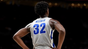 Former Memphis Tigers big man James Wiseman waits on the floor during a timeout. (Photo by Steve Dykes/Getty Images)