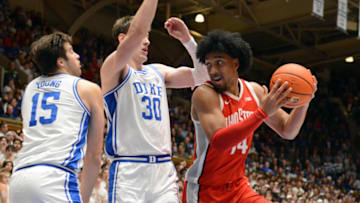 Nov 30, 2022; Durham, North Carolina, USA; Ohio State Buckeyes forward Justice Sueing (14) moves the ball against Duke Blue Devils center Kyle Filipowski (30) during the first half at Cameron Indoor Stadium. Mandatory Credit: Rob Kinnan-USA TODAY Sports