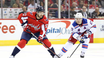 WASHINGTON, DC - OCTOBER 17: Evgeny Kuznetsov #92 of the Washington Capitals and Jesper Fast #17 of the New York Rangers go after the puck during the second period at Capital One Arena on October 17, 2018 in Washington, DC. (Photo by Will Newton/Getty Images)