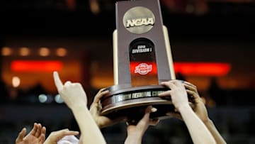 LOUISVILLE, KENTUCKY - MARCH 30: The Virginia Cavaliers raise the trophy after defeating the Purdue Boilermakers 80-75 in overtime of the 2019 NCAA Men's Basketball Tournament South Regional to advance to the Final Four at KFC YUM! Center on March 30, 2019 in Louisville, Kentucky. (Photo by Kevin C. Cox/Getty Images)