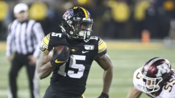 IOWA CITY, IOWA- NOVEMBER 16: Running back Tyler Goodson #15 of the Iowa Hawkeyes rushes up field during the second half in front of linebacker Mariano Sori-Marin #55 of the Minnesota Gophers on November 16, 2019 at Kinnick Stadium in Iowa City, Iowa. (Photo by Matthew Holst/Getty Images)