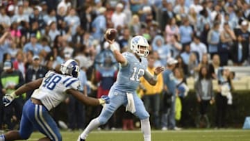 Nov 7, 2015; Chapel Hill, NC, USA; North Carolina Tar Heels quarterback Mitch Trubisky (10) looks to pass as Duke Blue Devils defensive end Deion Williams (48) defends in the fourth quarter. The Tar Heels defeated the Blue Devils 66-31 at Kenan Memorial Stadium. Mandatory Credit: Bob Donnan-USA TODAY Sports