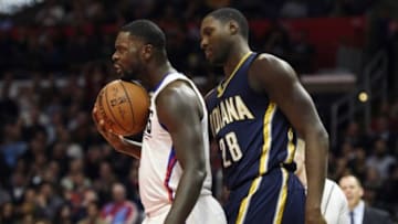 Dec 2, 2015; Los Angeles, CA, USA; Los Angeles Clippers forward Lance Stephenson (left) holds the ball with his chin as Indiana Pacers center Ian Mahinmi (28) attempts to take the ball out of play during the second quarter at Staples Center. Mandatory Credit: Kelvin Kuo-USA TODAY Sports