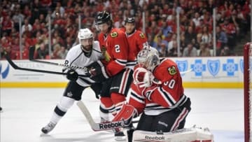 Jun 1, 2013; Chicago, IL, USA; Chicago Blackhawks goalie Corey Crawford (50) makes a save in front of defenseman Duncan Keith (2) and Los Angeles Kings defenseman Drew Doughty (8) during the second period in game one of the Western Conference finals of the 2013 Stanley Cup Playoffs at the United Center. Mandatory Credit: Rob Grabowski-USA TODAY Sports