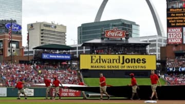 Jun 14, 2015; St. Louis, MO, USA; The St. Louis Cardinals grounds crew members cover the field during a rain delay in the game between the St. Louis Cardinals and the Kansas City Royals at Busch Stadium. Mandatory Credit: Jasen Vinlove-USA TODAY Sports