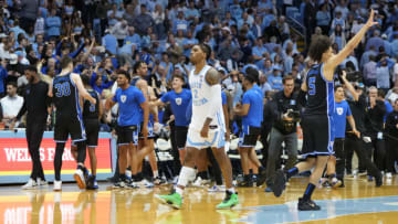 Mar 4, 2023; Chapel Hill, North Carolina, USA; Duke Blue Devils center Kyle Filipowski (30) and Duke Blue Devils guard Tyrese Proctor (5) and North Carolina Tar Heels guard Caleb Love (2) react after Duke wins at Dean E. Smith Center. Mandatory Credit: Bob Donnan-USA TODAY Sports