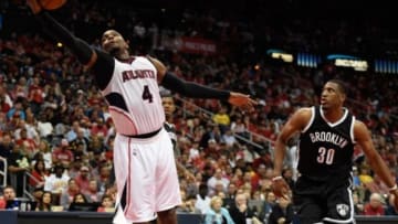 Apr 19, 2015; Atlanta, GA, USA; Atlanta Hawks forward Paul Millsap (4) catches a pass behind Brooklyn Nets forward Thaddeus Young (30) during the second half in game one of the first round of the NBA Playoffs at Philips Arena. The Hawks defeated the Nets 99-92. Mandatory Credit: Dale Zanine-USA TODAY Sports