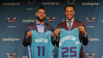 Jun 21, 2019; Charlotte, NC, USA; Charlotte Hornets 2019 NBA draft pick PJ Washington, right, the overall 12th pick, and Charlotte Hornets draft pick Cody Martin, 36th overall, hold Charlotte Hornets jerseys during a press conference at Spectrum Center. Mandatory Credit: Nell Redmond-USA TODAY Sports