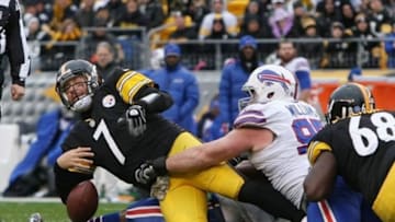 Nov 10, 2013; Pittsburgh, PA, USA; Pittsburgh Steelers quarterback Ben Roethlisberger (7) fumbles the ball as he is sacked by Buffalo Bills defensive tackle Kyle Williams (95( and defensive end Jerry Hughes (55) during the first quarter at Heinz Field. Roethlisberger recovered the fumble. Mandatory Credit: Jason Bridge-USA TODAY Sports