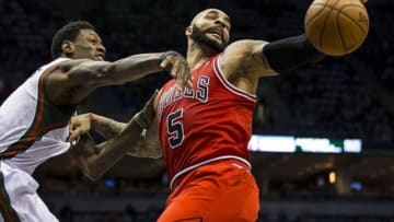 Jan 10, 2014; Milwaukee, WI, USA; Chicago Bulls forward Carlos Boozer (5) and Milwaukee Bucks center Larry Sanders (8) reach for a rebound during the third quarter at BMO Harris Bradley Center. Mandatory Credit: Jeff Hanisch-USA TODAY Sports