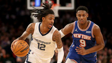 Feb 2, 2022; New York, New York, USA; Memphis Grizzlies guard Ja Morant (12) drives to the basket against New York Knicks guard RJ Barrett (9) during the third quarter at Madison Square Garden. Mandatory Credit: Brad Penner-USA TODAY Sports
