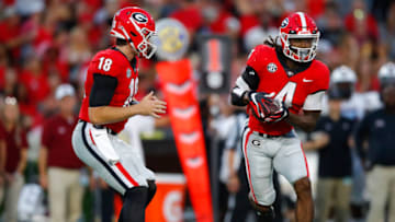 ATHENS, GA - SEPTEMBER 18: JT Daniels #18 hands off to James Cook #4 of the Georgia Bulldogs in the first half against the South Carolina Gamecocks at Sanford Stadium on September 18, 2021 in Athens, Georgia. (Photo by Todd Kirkland/Getty Images)