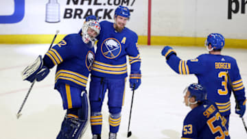 May 3, 2021; Buffalo, New York, USA; Buffalo Sabres goaltender Michael Houser (32) celebrates his first NHL win against the New York Islanders with teammates at KeyBank Center. Mandatory Credit: Timothy T. Ludwig-USA TODAY Sports