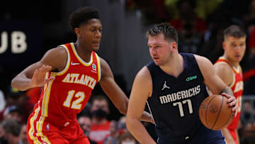 ATLANTA, GEORGIA - OCTOBER 21: Luka Doncic #77 of the Dallas Mavericks drives against De'Andre Hunter #12 of the Atlanta Hawks during the second half at State Farm Arena on October 21, 2021 in Atlanta, Georgia. NOTE TO USER: User expressly acknowledges and agrees that, by downloading and or using this photograph, User is consenting to the terms and conditions of the Getty Images License Agreement. (Photo by Kevin C. Cox/Getty Images)