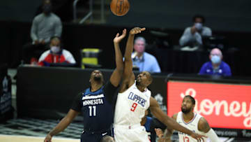 LOS ANGELES, CALIFORNIA - DECEMBER 29: Naz Reid #11 of the Minnesota Timberwolves tips off against Serge Ibaka #9 of the LA Clippers during the first half of a game at Staples Center on December 29, 2020 in Los Angeles, California. (Photo by Sean M. Haffey/Getty Images)