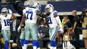 ARLINGTON, TEXAS - SEPTEMBER 08: Ezekiel Elliott #21 of the Dallas Cowboys celebrates after scoring a touchdown with teammate offensive tackle Tyron Smith (77) during an NFL football game against the New York Giants on September 8, 2019 in Arlington, Texas. (Photo by Cooper Neill/Getty Images)