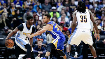 Nov 10, 2016; Denver, CO, USA; Denver Nuggets guard Emmanuel Mudiay (0) dribbles the ball against Golden State Warriors guard Stephen Curry (30) in the third quarter at the Pepsi Center. The Warriors defeated the Nuggets 125-101. Mandatory Credit: Isaiah J. Downing-USA TODAY Sports