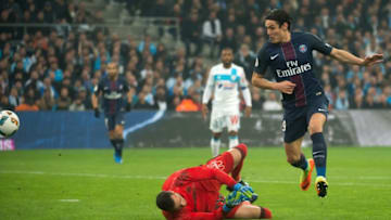 Paris Saint-Germain's Uruguayan forward Edinson Cavani (R) scores despite Olympique de Marseille's French goalkeeper Yohann Pele (L) during the French L1 football match Olympique de Marseille vs Paris Saint-Germain on February 26, 2017 at the Velodrome stadium in Marseille, southern France. / AFP / BERTRAND LANGLOIS (Photo credit should read BERTRAND LANGLOIS/AFP/Getty Images)