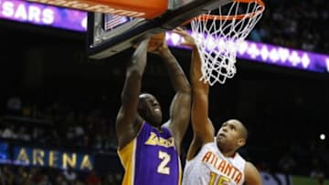 Dec 4, 2015; Atlanta, GA, USA; Los Angeles Lakers forward Brandon Bass (2) dunks over Atlanta Hawks center Al Horford (15) in the second quarter at Philips Arena. Mandatory Credit: Brett Davis-USA TODAY Sports