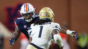 Auburn footballAUBURN, ALABAMA - SEPTEMBER 04: Quarterback Kato Nelson #1 of the Akron Zips looks to run the ball by linebacker Owen Pappoe #0 of the Auburn Tigers at Jordan-Hare Stadium on September 04, 2021 in Auburn, Alabama. (Photo by Michael Chang/Getty Images)