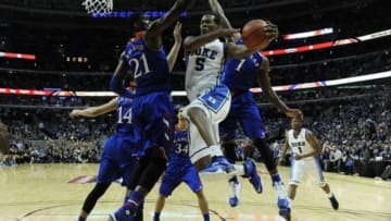 Nov 12, 2013; Chicago, IL, USA; Duke Blue Devils forward Rodney Hood (5) shoots as Kansas Jayhawks center Joel Embiid (21) defends during the first half at United Center. Mandatory Credit: David Banks-USA TODAY Sports