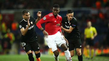MANCHESTER, ENGLAND - MARCH 13: Paul Pogba of Manchester United battles with Gabriel Mercado and Pablo Sarabia of Sevilla during the UEFA Champions League Round of 16 Second Leg match between Manchester United and Sevilla FC at Old Trafford on March 13, 2018 in Manchester, United Kingdom. (Photo by Clive Mason/Getty Images)
