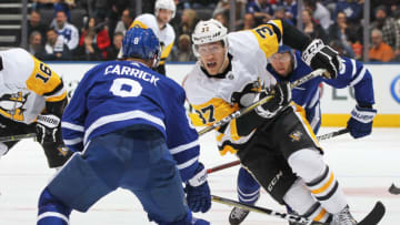 TORONTO, ON - MARCH 10: Carter Rowney #37 of the Pittsburgh Penguins skates in on Connor Carrick #8 of the Toronto Maple Leafs during an NHL game at the Air Canada Centre on March 10, 2018 in Toronto, Ontario, Canada. The Maple Leafs defeated the Penguins 5-2. (Photo by Claus Andersen/Getty Images)
