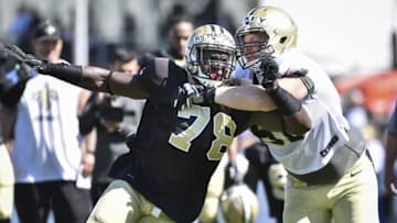 Aug 3, 2015; White Sulphur Springs, WV, USA; New Orleans Saints defensive lineman Bobby Richardson (78) fights past tackle Sean Hickey (61) during training camp at The Greenbrier. Mandatory Credit: Michael Shroyer-USA TODAY Sports