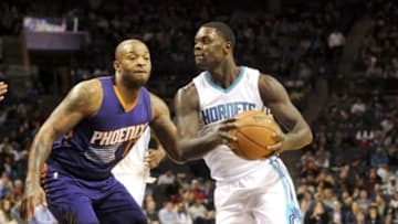 Dec 17, 2014; Charlotte, NC, USA; Charlotte Hornets guard Lance Stephenson (1) drives past Phoenix Suns forward P.J. Tucker (17) during the second half of the game at Time Warner Cable Arena. The Suns win 111-106. Mandatory Credit: Sam Sharpe-USA TODAY Sports