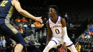 NEW YORK, NEW YORK - NOVEMBER 21: Marcus Garrett #0 of the Kansas Jayhawks dribbles the ball during the first half of the game against Marquette Golden Eagles during the NIT Season Tip-Off tournament at Barclays Center on November 21, 2018 in the Brooklyn borough of New York City. (Photo by Sarah Stier/Getty Images)