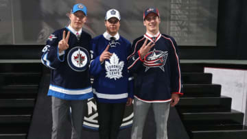 BUFFALO, NY - JUNE 24: (L-R) Patrik Laine, selected second overall by the Winnipeg Jets, Auston Matthews, selected first overall by the Toronto Maple Leafs, and Pierre-Luc Dubois, selected third overall by the Columbus Blue Jackets, stand onstage during round one of the 2016 NHL Draft at First Niagara Center on June 24, 2016 in Buffalo, New York. (Photo by Dave Sandford/NHLI via Getty Images)